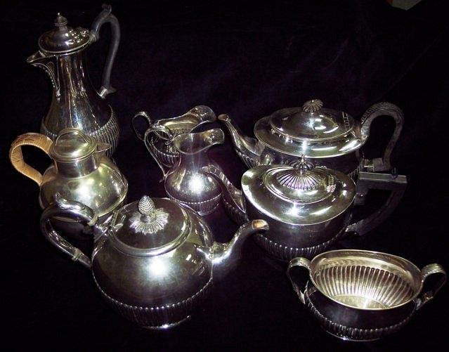 Appraisal: A four-piece tea service of half ribbed form and sundry