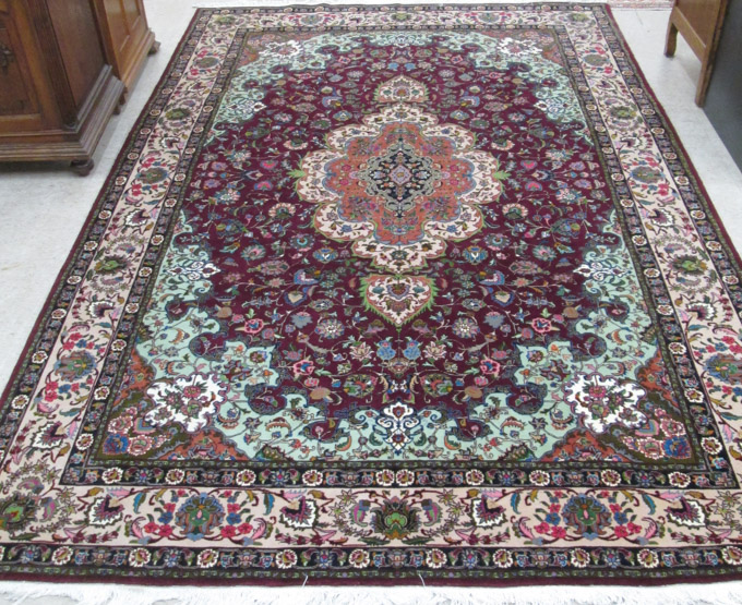 Appraisal: FINE PERSIAN CARPET hand knotted in a floral and central