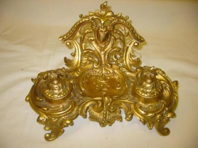 Appraisal: A GILT METAL ROCOCO STYLE DESK STAND the raised back