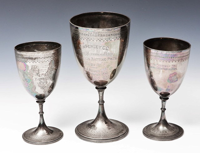 Appraisal: A PAIR OF VICTORIAN SILVER TROPHY CUPS on flared feet