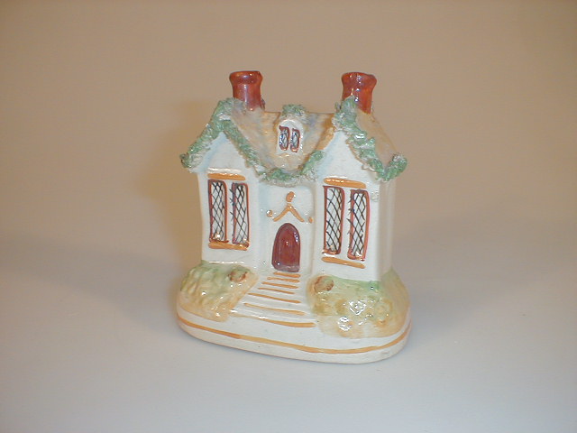 Appraisal: A thC Staffordshire Estate Cottage money box with two red