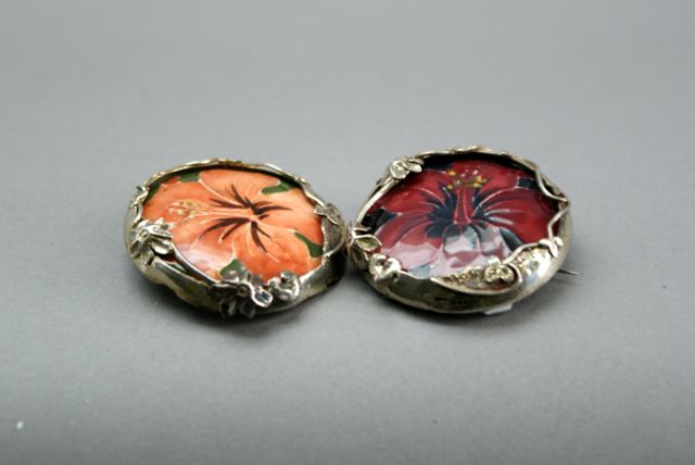 Appraisal: A pair of Moorcroft brooches each decorated with a pansy