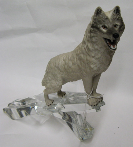 Appraisal: PORCELAIN WHITE WOLF AND GLASS SCULPTURE the wolf standing at