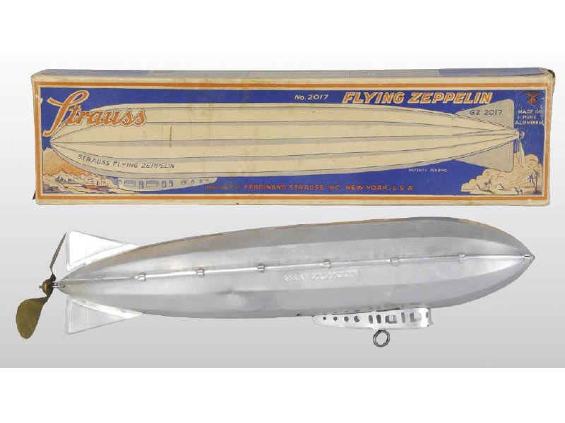 Appraisal: Strauss Tin Wind-Up Flying Zeppelin with Box Description Original box