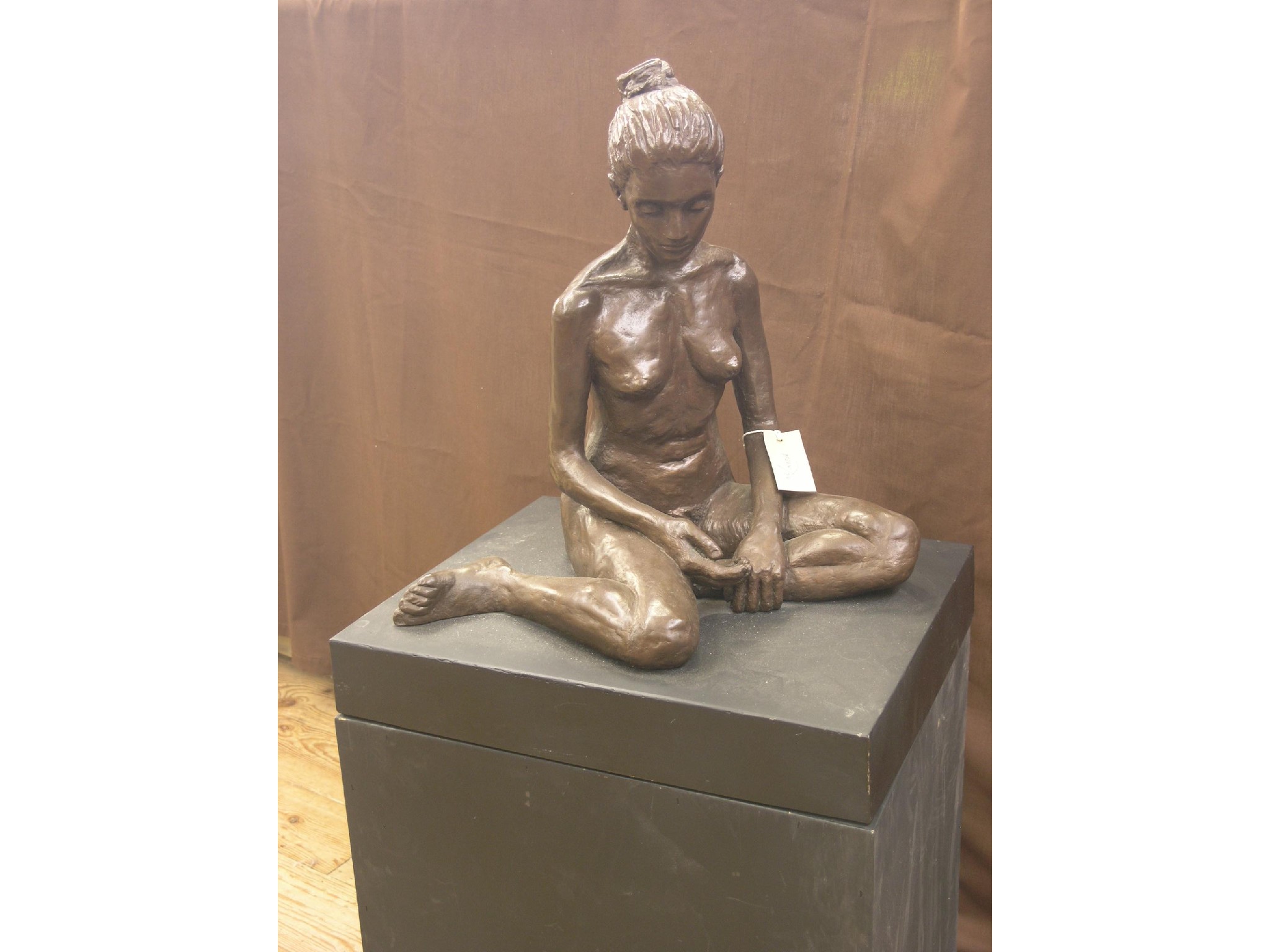 Appraisal: A contemporary bronze portrait study seated nude female unsigned on