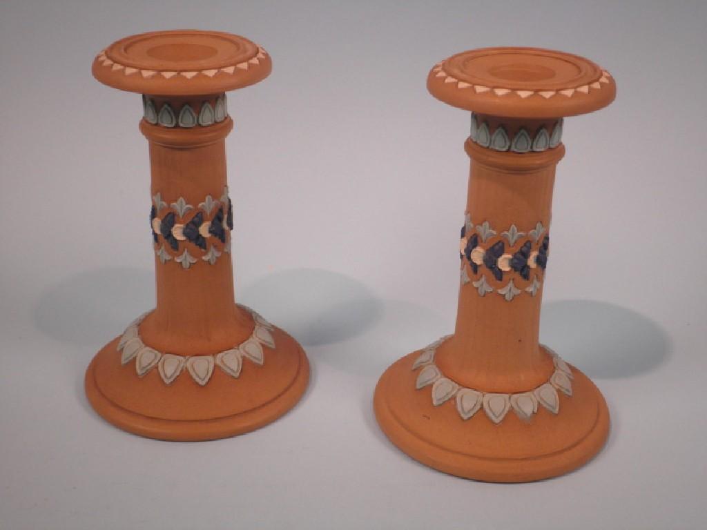 Appraisal: A pair of Doulton silicone ware candlesticks each decorated with