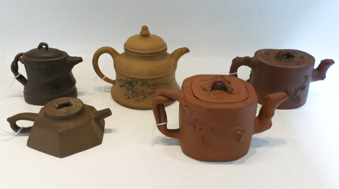 Appraisal: FIVE ASIAN POTTERY TEAPOTS in various forms and with assorted