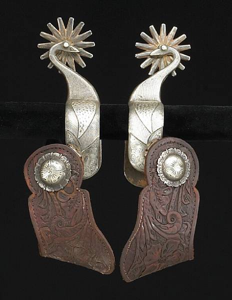 Appraisal: A pair of unmarked silver-mounted swan spurs Double mounted overlaid