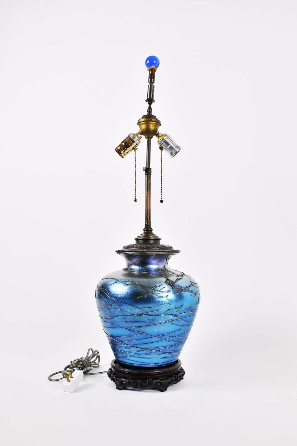 Appraisal: BLUE IRIDESCENT GLASS VASE MOUNTED AS A LAMPPossibly American The