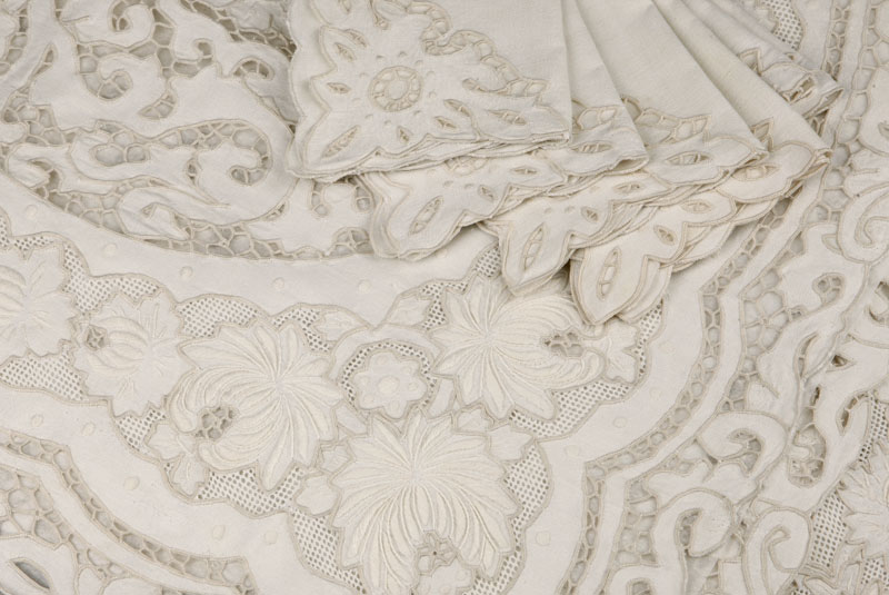 Appraisal: A Belgian ivory linen and lace tablecloth and place mats