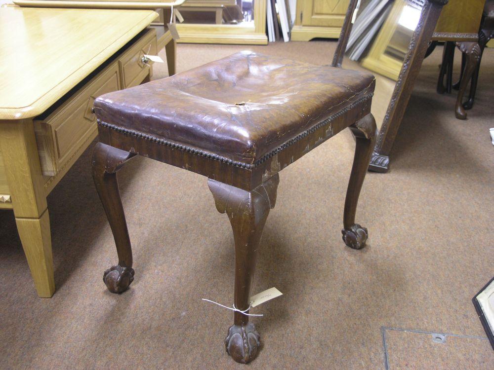 Appraisal: A mahogany stool with brown leather seat on cabriole legs