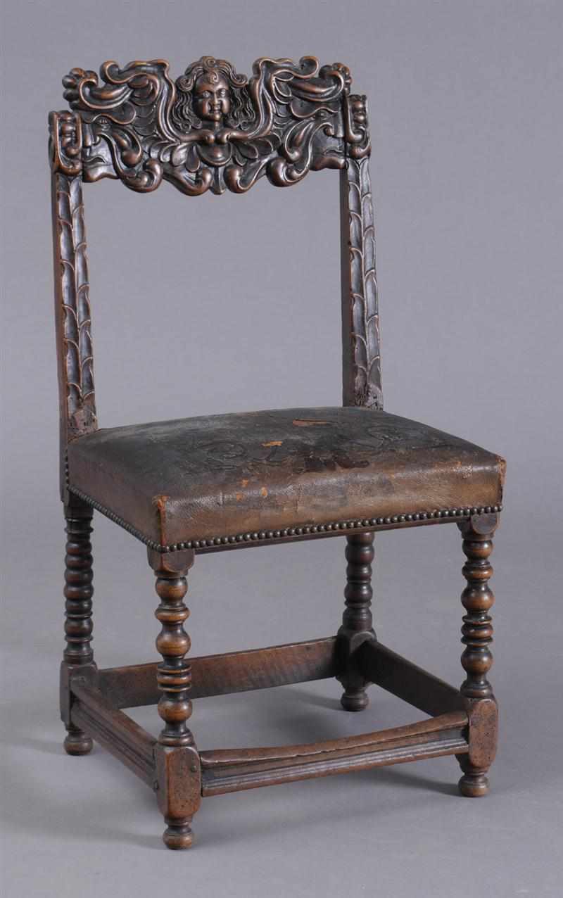 Appraisal: FLEMISH BAROQUE CARVED WALNUT SIDE CHAIR The cherub head top