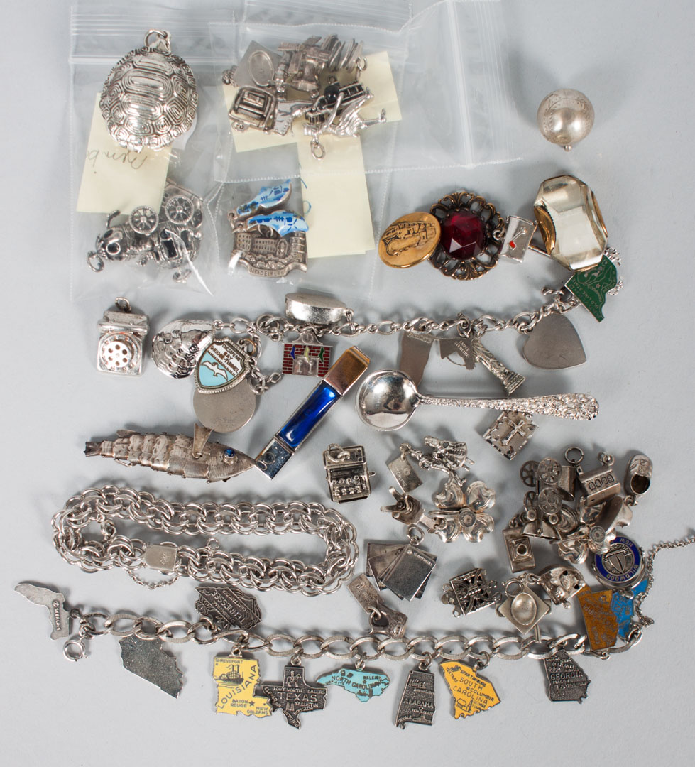 Appraisal: Assortment of silver jewelry including charm bracelets one missing clasp