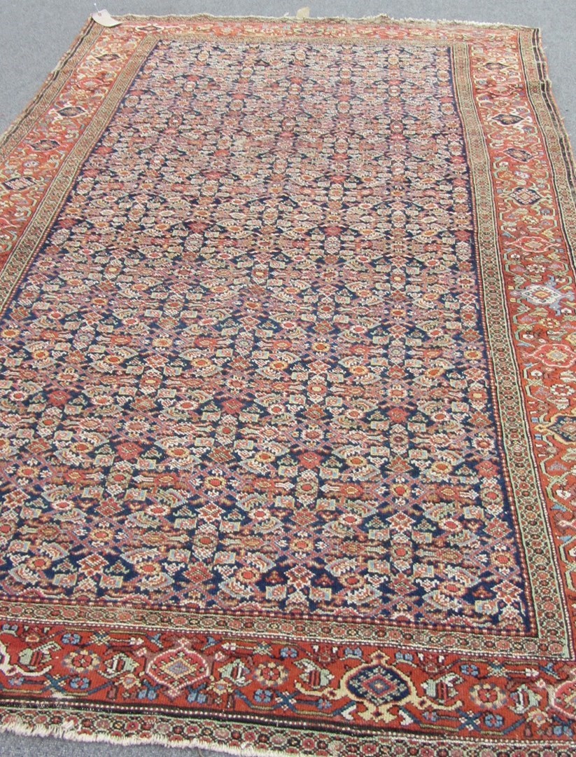 Appraisal: A Fereghan rug Persian the indigo field with an all