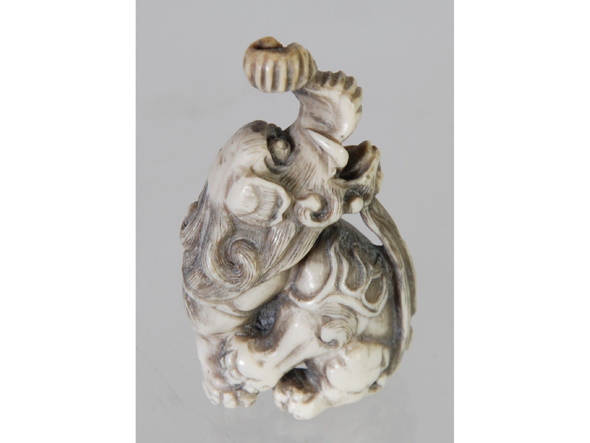 Appraisal: AN ORIENTAL CARVED NETSUKE in the form of an elephant