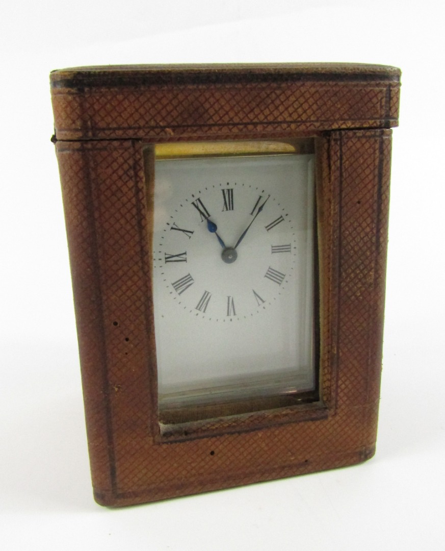 Appraisal: A late thC brass carriage clock with leaf scroll handle