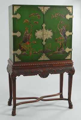 Appraisal: A Chinoiserie Decorated Lacquered Wood Cabinet on Carved Mahogany Stand