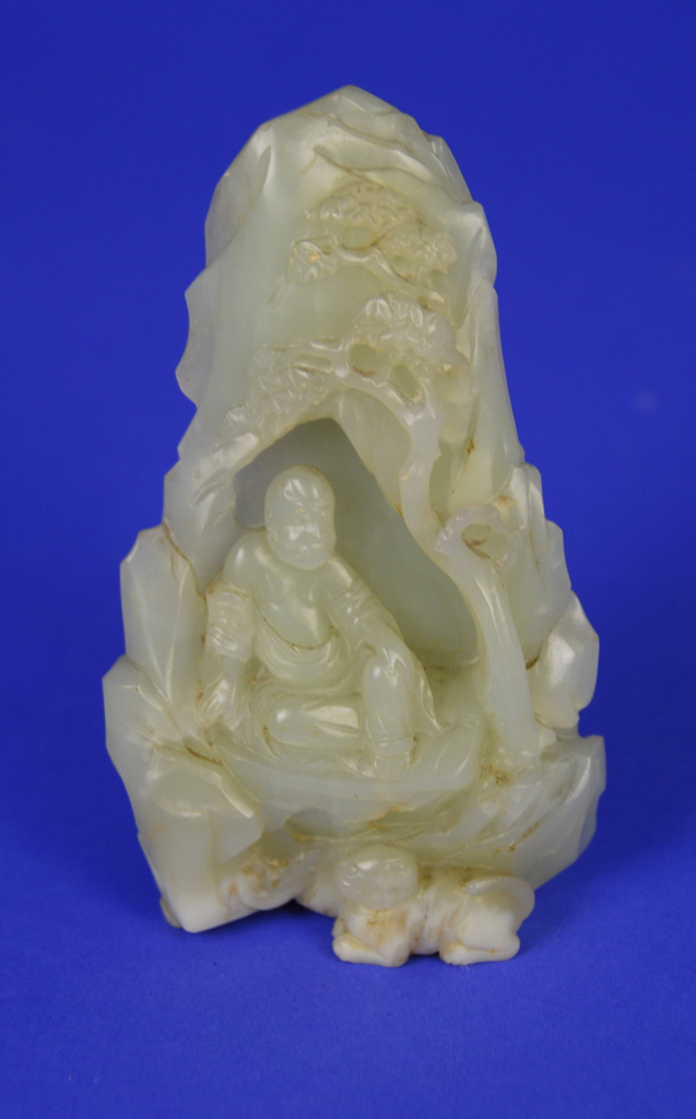 Appraisal: CHINESE CARVED JADE FIGURE seated in a rock and tree