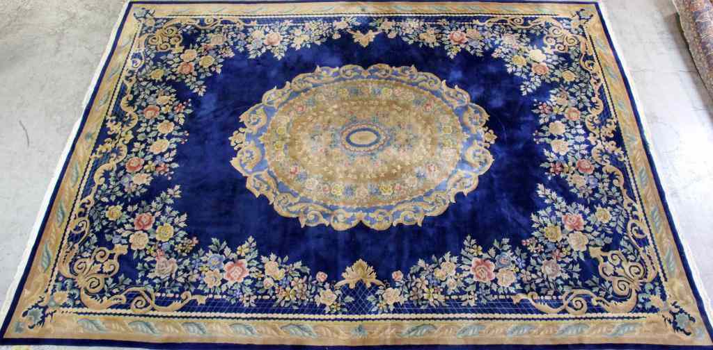 Appraisal: Large Wool Persian CarpetHaving royal blue ground with cream scroll