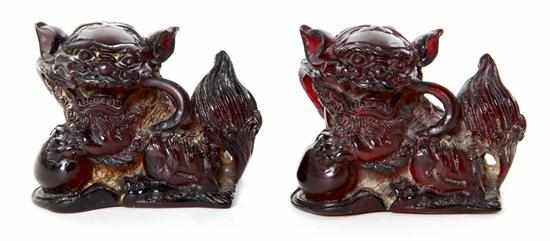 Appraisal: Chinese carved amber guardian lions two shishi figures with paws