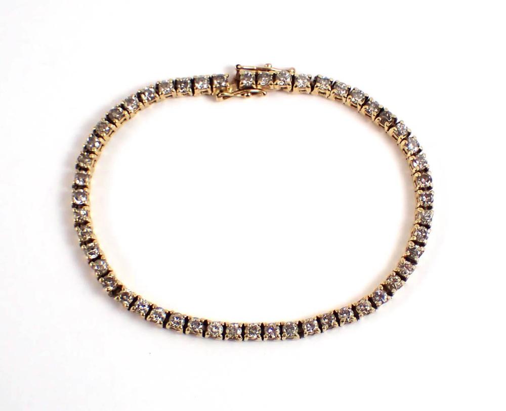 Appraisal: DIAMOND AND FOURTEEN KARAT GOLD TENNIS BRACELET measuring in length