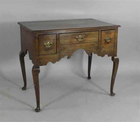 Appraisal: A George II oak lowboy with three drawers on cabriole