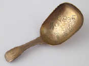 Appraisal: A Georgian silver fiddle handled squared bowl caddy ladle with