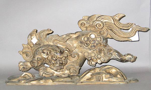 Appraisal: A giltwood architectural fragment Depicting Shishi dog with similar stand