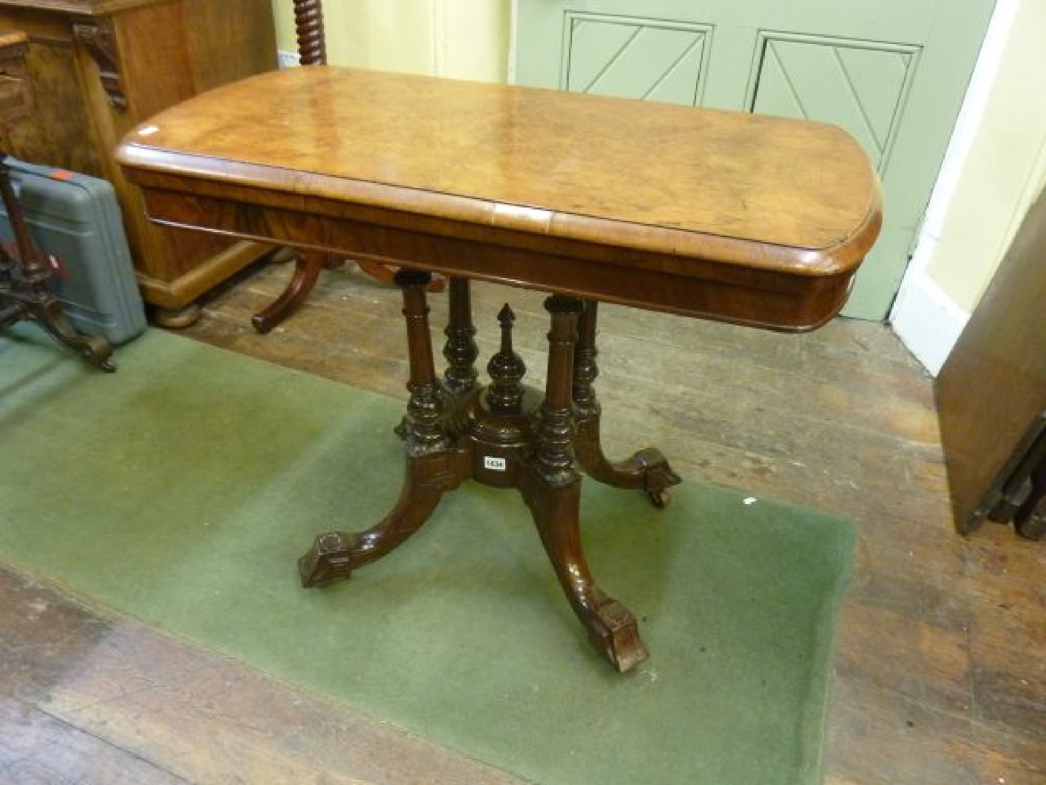 Appraisal: A Victorian walnut fold over top card table of rectangular