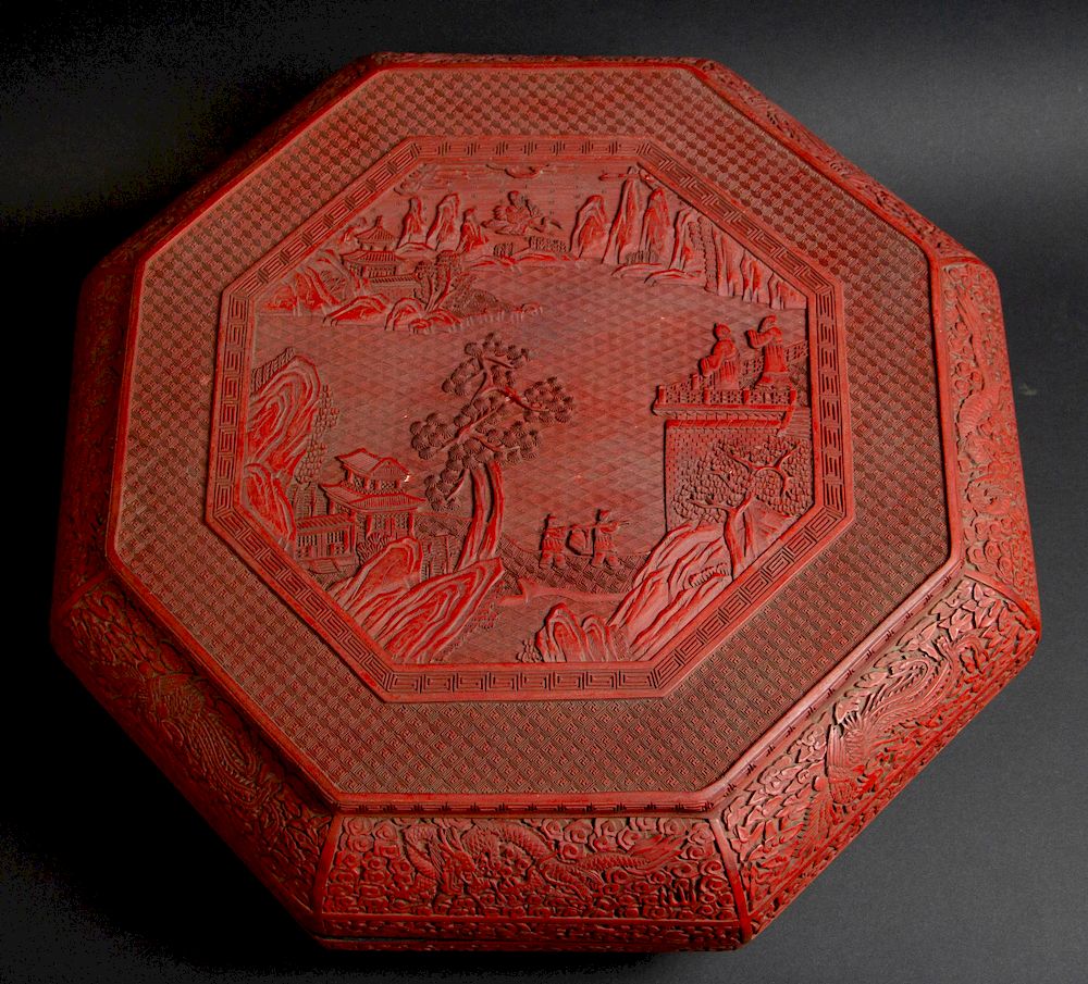 Appraisal: A Magnificent Octagonal Carved Cinnabar Box Chinese A central landscape