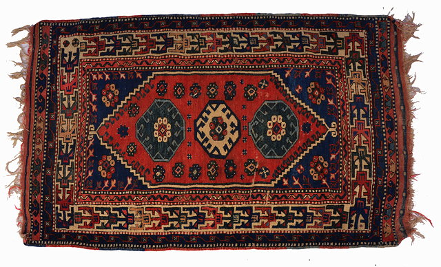 Appraisal: AN ANTIQUE TURKISH BERGAMA RUG with three geometric medallions on