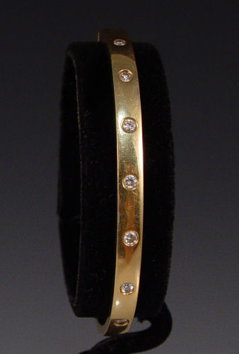 Appraisal: K BANGLE BRACELET WITH DIAMONDS K yellow gold bangle bracelet