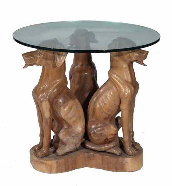 Appraisal: A STYLISED OCCASIONAL TABLE supported by three carved and seated