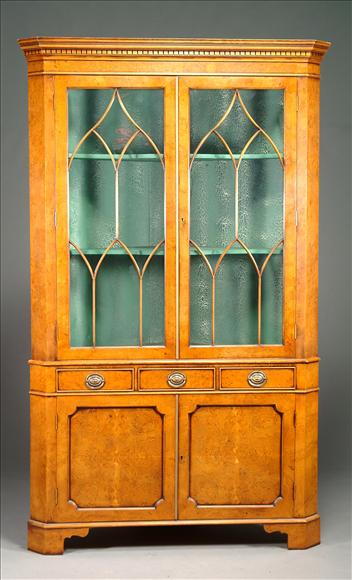 Appraisal: A pollard oak standing corner cabinet in George III style