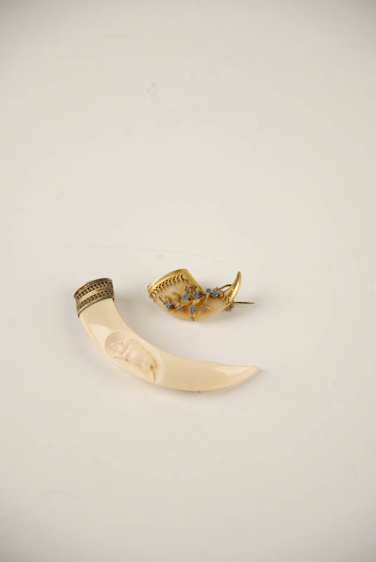 Appraisal: Two Animal Tooth Claw Brooches a boar's tusk intaglio carved