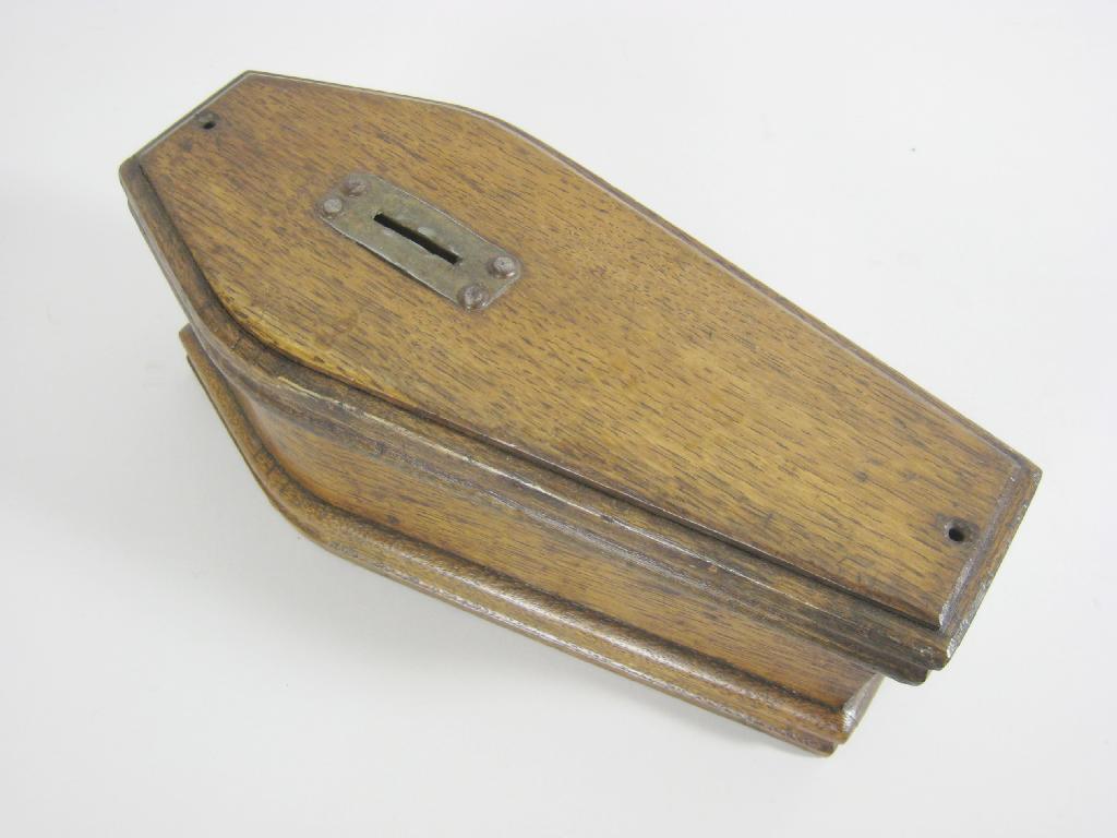 Appraisal: An oak Money Box in the form of a coffin