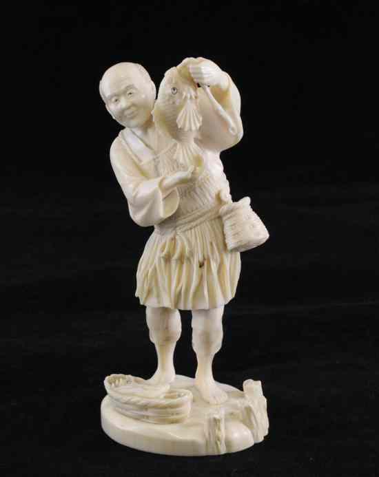 Appraisal: A Japanese ivory figure of a fisherman holding his catch