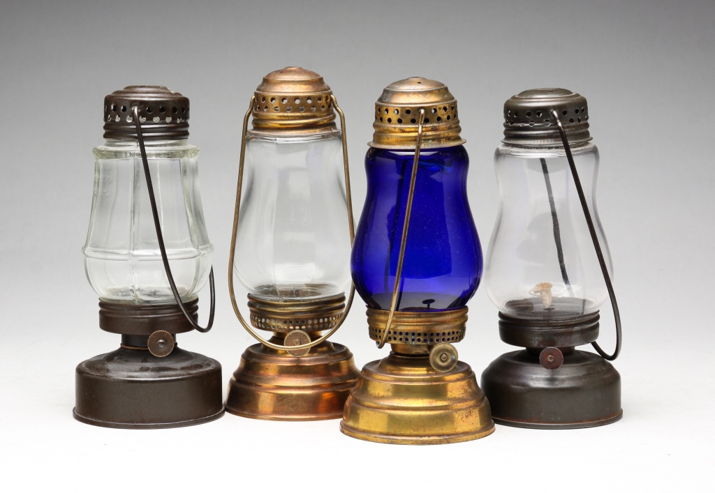 Appraisal: FOUR SKATERS LAMPS American second half th century Kerosene lamps