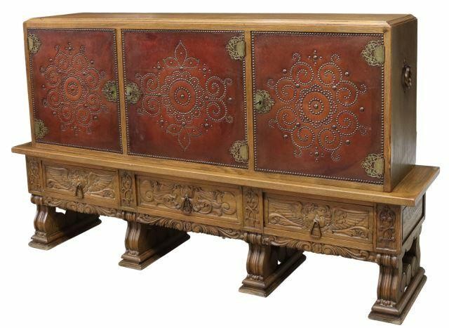 Appraisal: Spanish carved oak sideboard th c three leather-clad cabinet doors