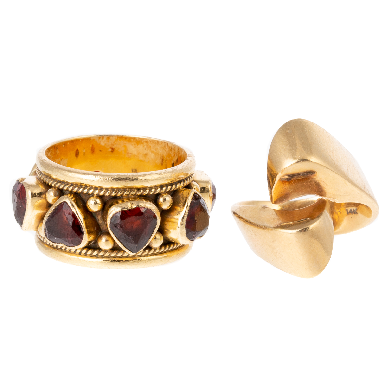 Appraisal: A WIDE GARNET BAND RIBBON RING IN K K yellow