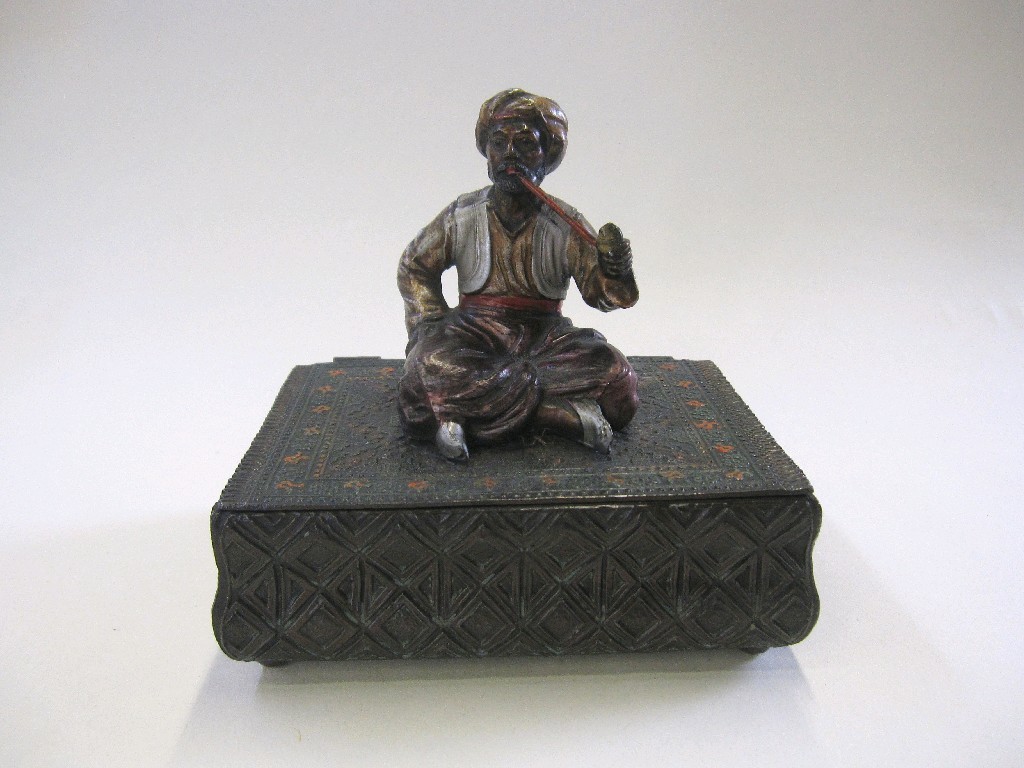 Appraisal: Painted spelter box mounted with an Arab figure smoking a