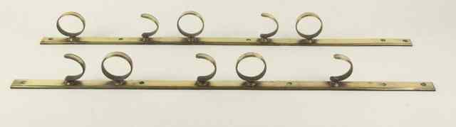 Appraisal: A pair of brass five-gun hanging brackets cm wide