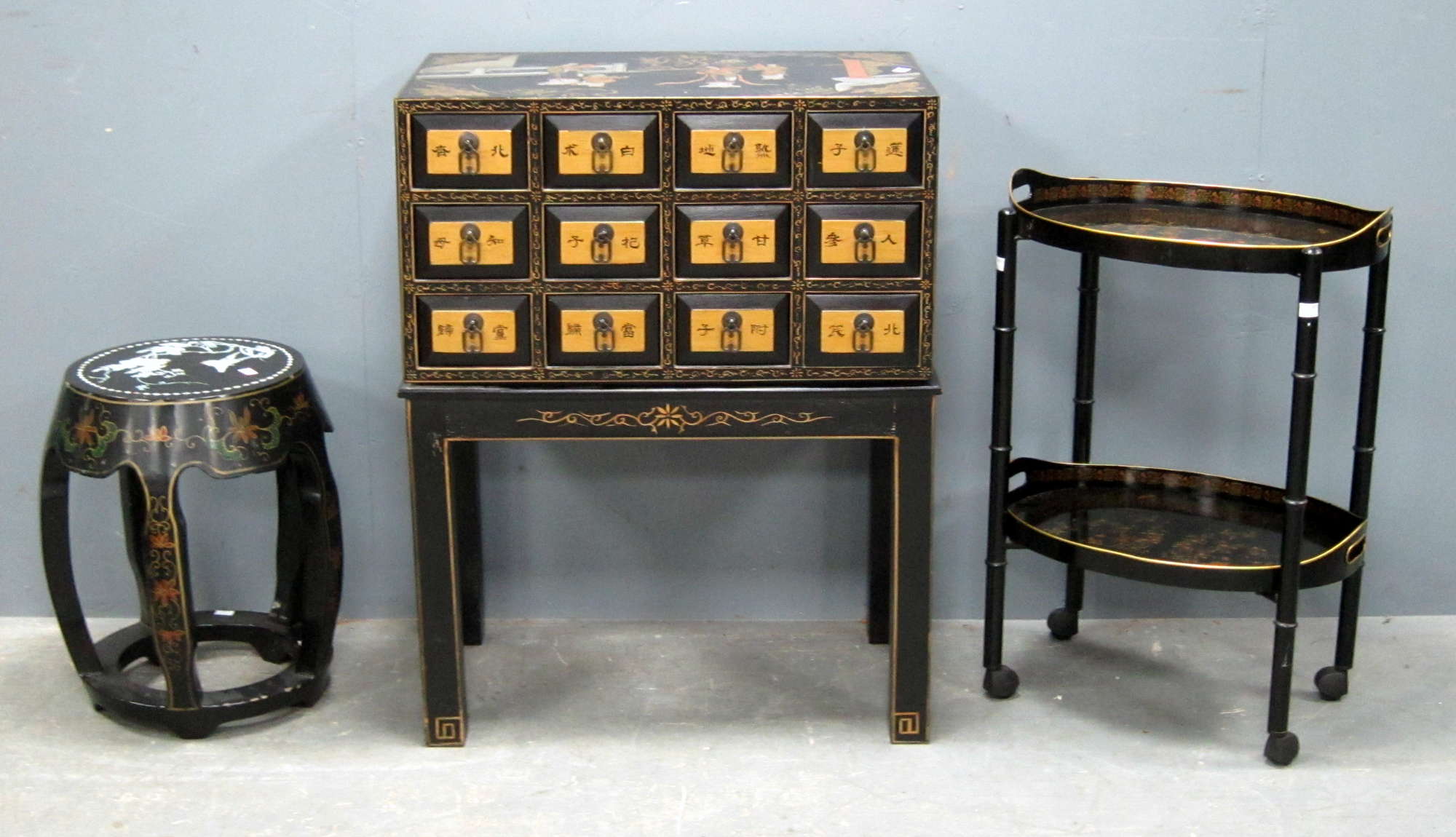 Appraisal: Black lacquered storage chest on stand decorated in the Japanese