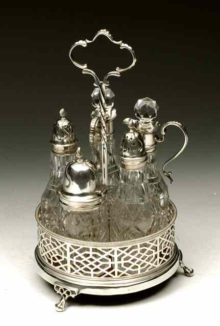 Appraisal: A VICTORIAN FIVE BOTTLE CRUET SET WITH SILVER MOUNTS circular