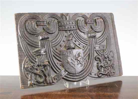 Appraisal: An th century carved oak panel decorated with an armorial