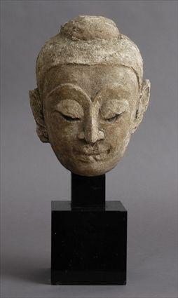 Appraisal: BURMESE SANDSTONE HEAD OF BUDDHA With serene smile and down