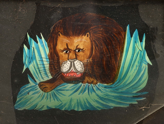 Appraisal: A VICTORIAN MECHANICAL MAGIC LANTERN SLIDE depicting a lion looking