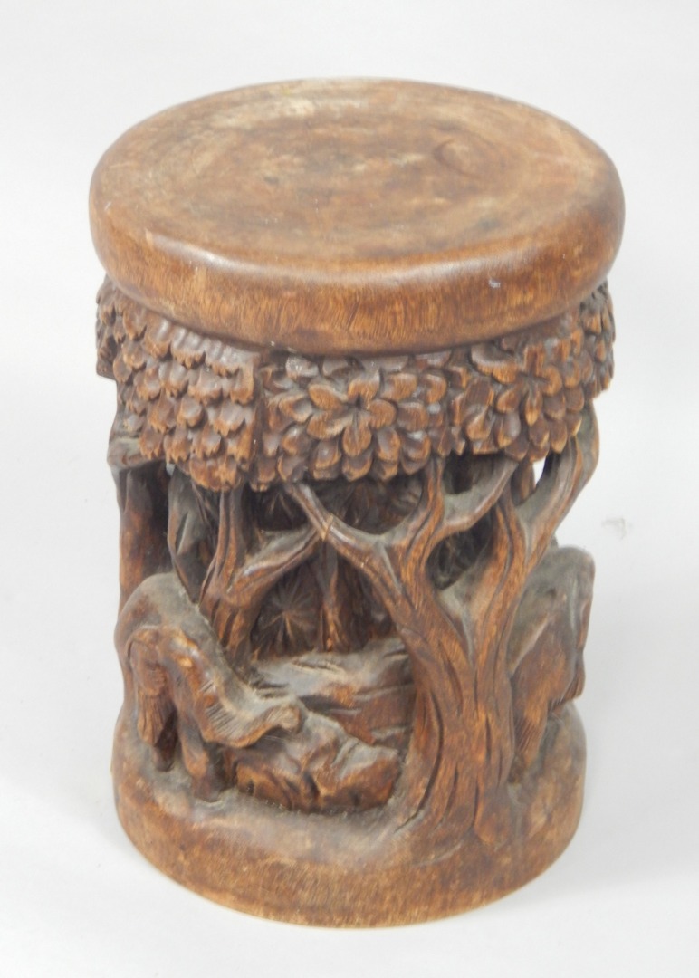 Appraisal: An Indian solid hardwood stool carved to the sides in