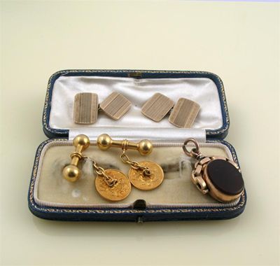 Appraisal: Two pairs of gold cufflinks and a gold spinning fob