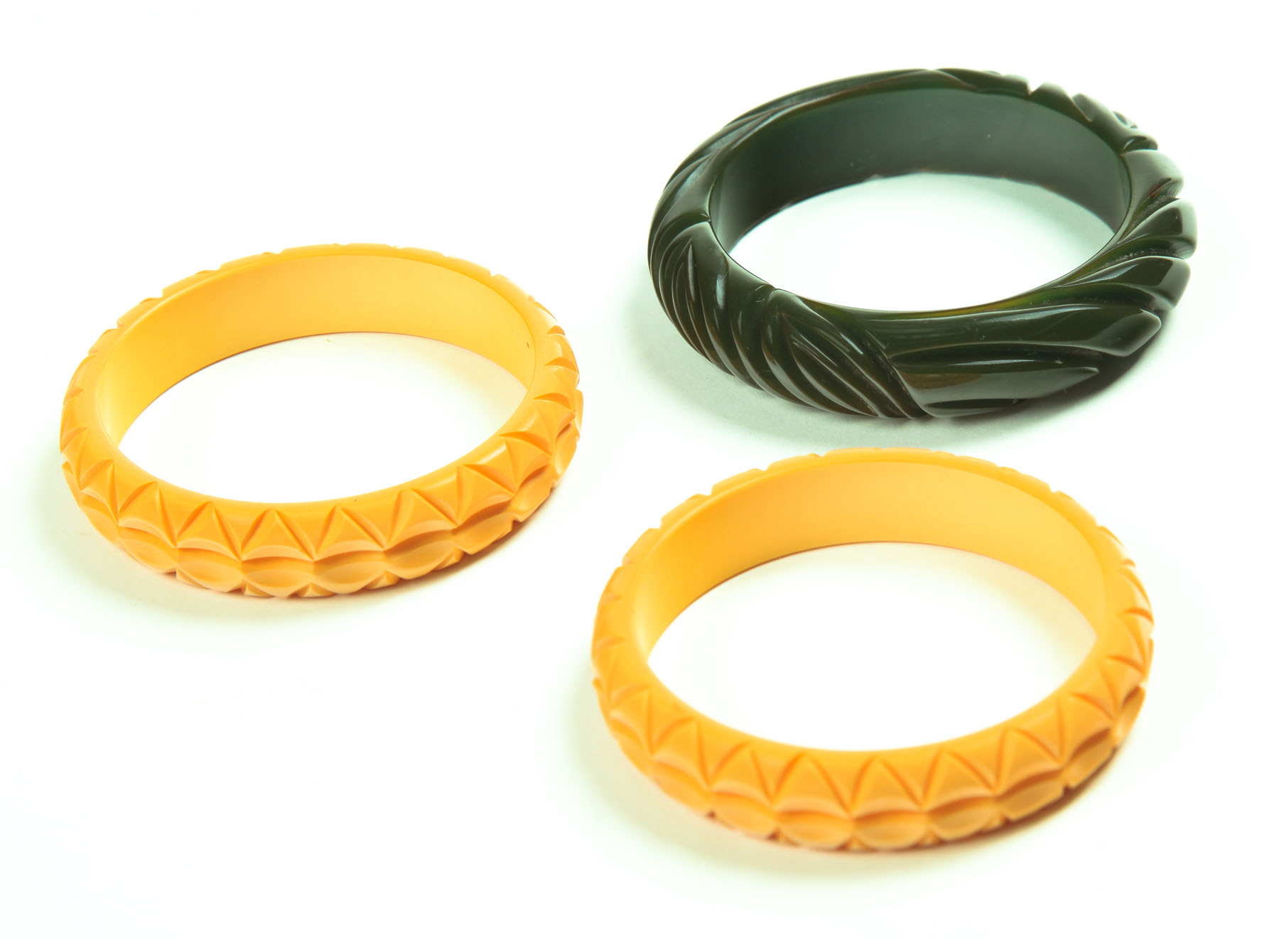 Appraisal: THREE BAKELITE BRACELETS American st half- th century Yellow bangle